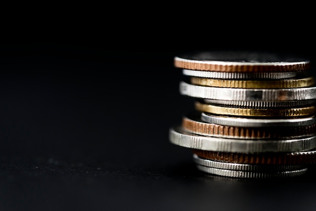 Stacked Coins Against A Dark Background